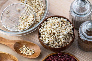 Hot Boiled Job’s Tears millet seed from boiler. White boiled Job’s Tears is highly nutritious cereal healthy fresh organic in salad dish.