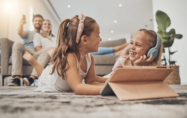 Happy kids on floor of living room with tablet, headphones and watching video, movie streaming or music. Digital game, online app and girl children relax on carpet together with fun in family home. - obrazy, fototapety, plakaty