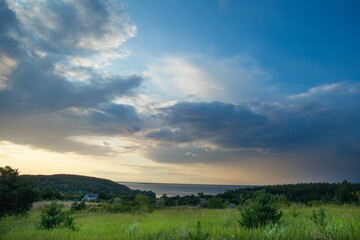 Obraz premium Landscape image of countryside of Ukraine. Cloudy sky, grassy fields and rolling hills rural scenery