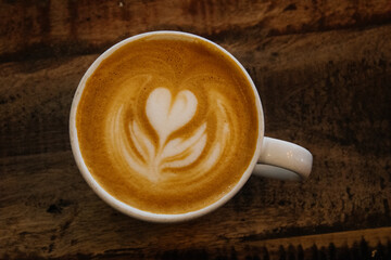 A cup of gourmet coffee on a wooden table