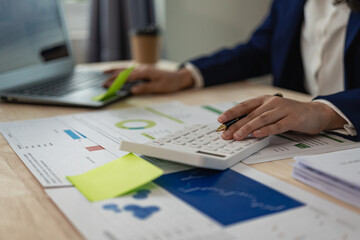 Auditor and accountant working in office Analyze financial data and accounting records with a calculator. Accounting companies provide financial and tax planning services. Close-up pictures