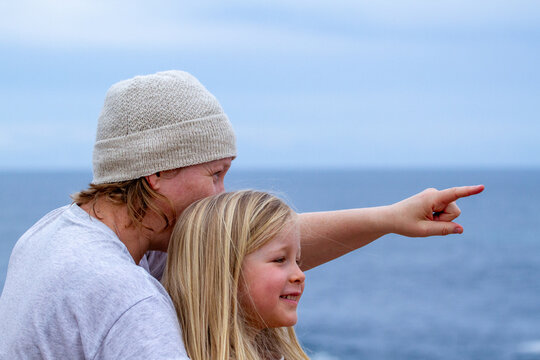 Mother Pointing Out Something To 5 Year Old Daughter At Seaside.