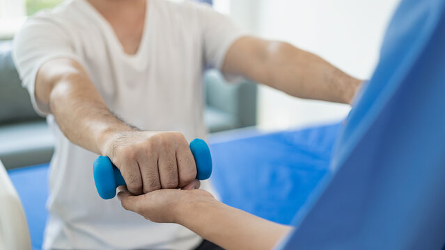 A doctor or physical therapist works to determine arm treatment, muscle stretching and exercises, doing pain therapy, rehabilitation, effectiveness in the clinic. Close-up pictures