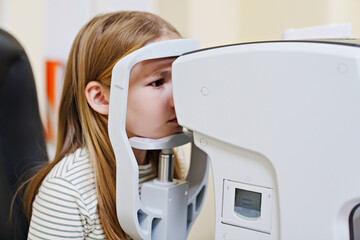 teen girl in ophthalmologist's office. computed tomography of the eye
