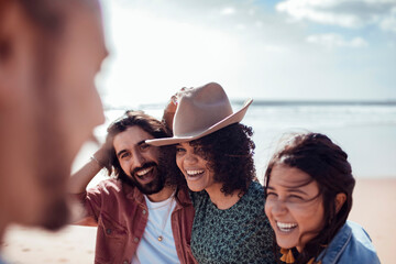 Diverse group of friends walking on the beach together
