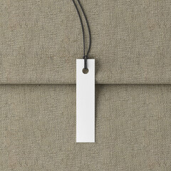 White long tag mockup on fabric background. View directly above