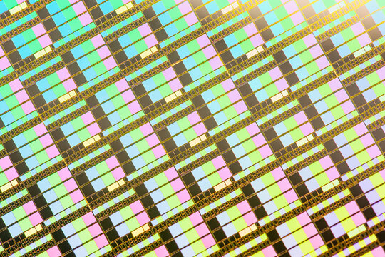 A pattern of microprocessor circuits on a silicon wafer. The semiconductors or central processing unit CPU microchips are fabricated from a silicon wafer with patterned layers of various materials.