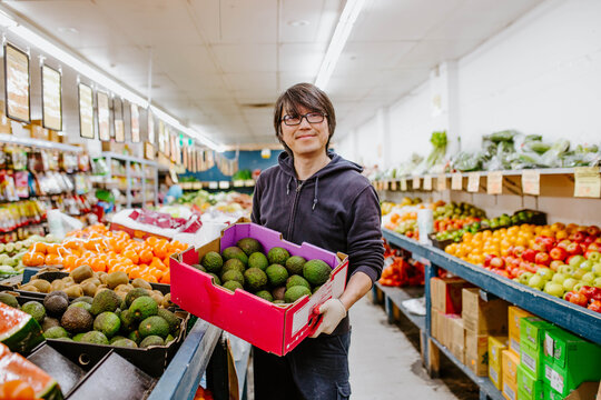 Chinese man working in fruit supermarket