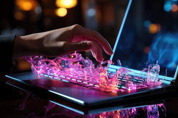 Close-up of a woman's hand over a laptop keyboard in neon color