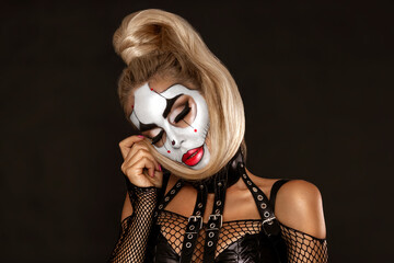 Sexy woman in a Halloween makeup on black background.