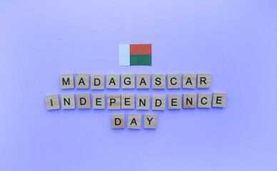 December 30, Republic Day of Madagascar, minimalistic banner with the inscription in wooden letters on a blue background