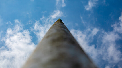a pole against a cloudy blue sky background