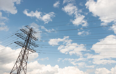 power line tower and blue sky with clouds