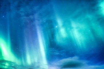 Bright and active Aurora borealis or Northern lights glowing in the night sky on Arctic circle