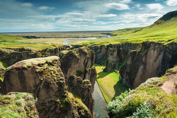 Rugged Fjadrargljufur canyon with Fjadra river flowing in summer at Iceland