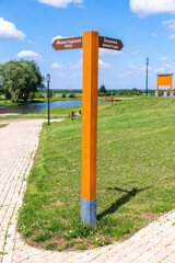 Fototapeta premium Direction indicator at the Nativity Bobrenev convent in Kolomna, Russia. Text in russian: Monastery pond, Bobrenev monastery