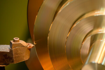 Closeup scene the lathe machine finish cut the brass parts by lathe tools.