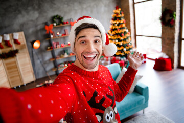 Photo of excited positive funky person make selfie arm demonstrate welcome newyear decorated house...