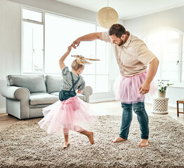 Family, dance or ballet with a father and daughter together in costume, having fun in the home living room. Love, kids or fantasy and a girl child dancing with her man parent on a carpet in the house