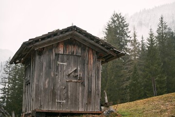 Fototapeta na wymiar An Old House in the European Alps. Old Cabin in the mountains