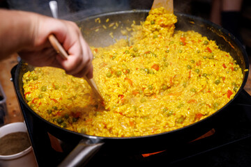 Cooking risotto in a frying pan.