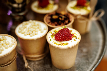 Mug cakes with raspberry in paper cups.