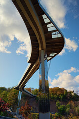 Low angle view of New Pedestrian Bridge (also called Klitschko Bridge) against blue sky. Bridge with glass floor. Modern architecture with glass and steel. Travel and tourism concept