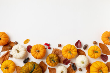 Autumn holiday background from pumpkins, colorful dried leaves and fall decorations. Happy...
