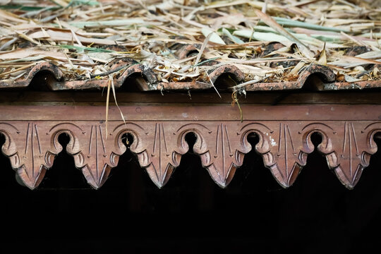 Omah Limasan or Traditional javanese joglo house or rumah joglo roof with ornament is covered with dried bamboo leaves. Concept for dry season, drought, autumn, rural village housing and storm.