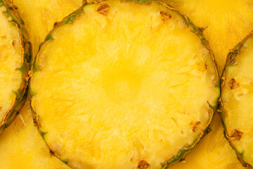 Pineapple juicy yellow slices as a background.