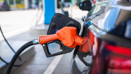 Gasoline being refilled at a petrol station. Refueling Diesel fuel is used to power a car..