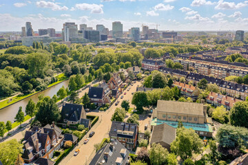 an aerial view of some buildings and trees in the distance, with a river running through the middle part of the city