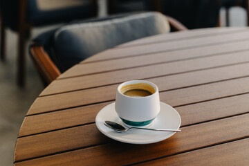 Cup of black coffee on a table in a cafe.
