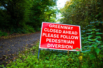 warning sign that the footpath is closed ahead pedestrians to follow a diversion