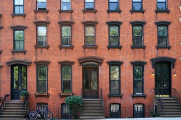 Facade of old fashioned brick apartment building or townhouse in New York City