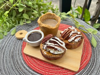 Eatable cup of Coffee and baked potatoes with chocolate mixed milk ice cream