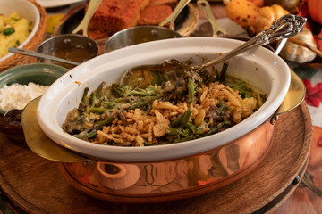 Vegan baked  green beeans and crispy onions in vintage serving ceramic and copper pot