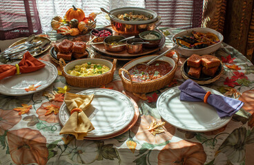 Vegan  Thanksgiving table setting consisting of traditional but vegan dishes: beans, chili, corn bread, roasted squash, mashed potatoes