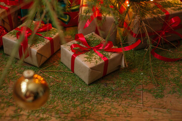 The floor and gifts strewn with fallen needles from a dead Christmas tree.