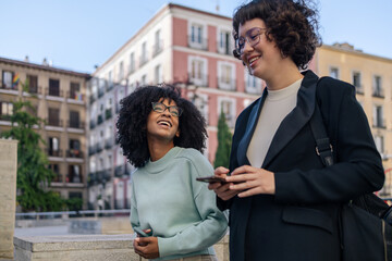 Female friends walking around in the city