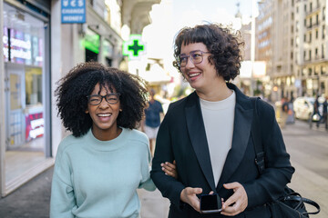 Two friends laughing in the street