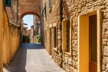 Fototapeta na wymiar The beautiful village of Bibbona on a sunny summer afternoon. Province of Livorno, Tuscany, Italy.