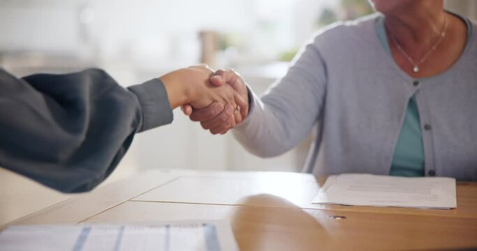 Handshake, deal and an insurance agent with a senior person in the home for finance or retirement planning. Thank you, contract and people shaking hands closeup for an investment or savings agreement