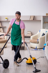 Young male contractor cleaner looking after newborn