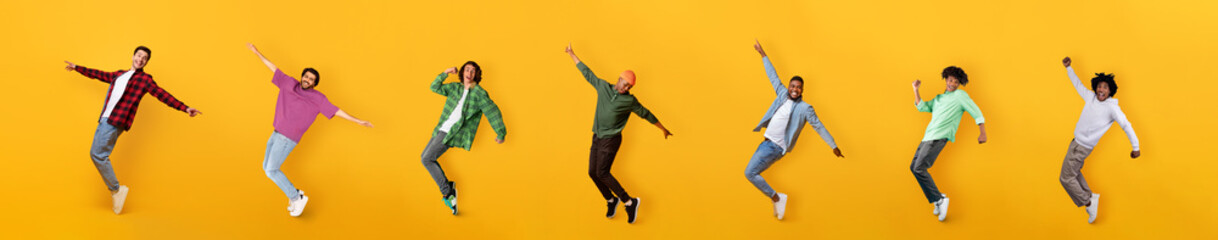 Happy multiethnic millennial guys dancing on colorful orange backgrounds