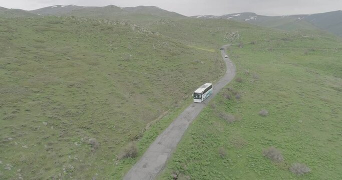 Drone shot of a tourists bus on the mountain road of Amberd on Mount Aragats in Aragatsotn, Armenia