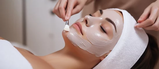 Papier Peint photo Salon de beauté young woman having facial mask spa therapy in beauty salon