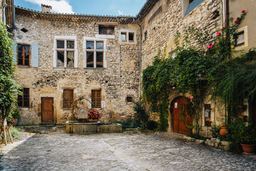 Old stone house facades on the Place de la Concorde in the medieval village of Chatillon en Diois, in the south of France (Drome) - obrazy, fototapety, plakaty
