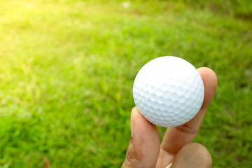 hand picking up golf ball.