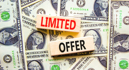 Limited offer symbol. Concept words Limited offer on beautiful wooden block. Beautiful background from dollar bills. Dollar bills. Business marketing, motivational Limited offer concept. Copy space.